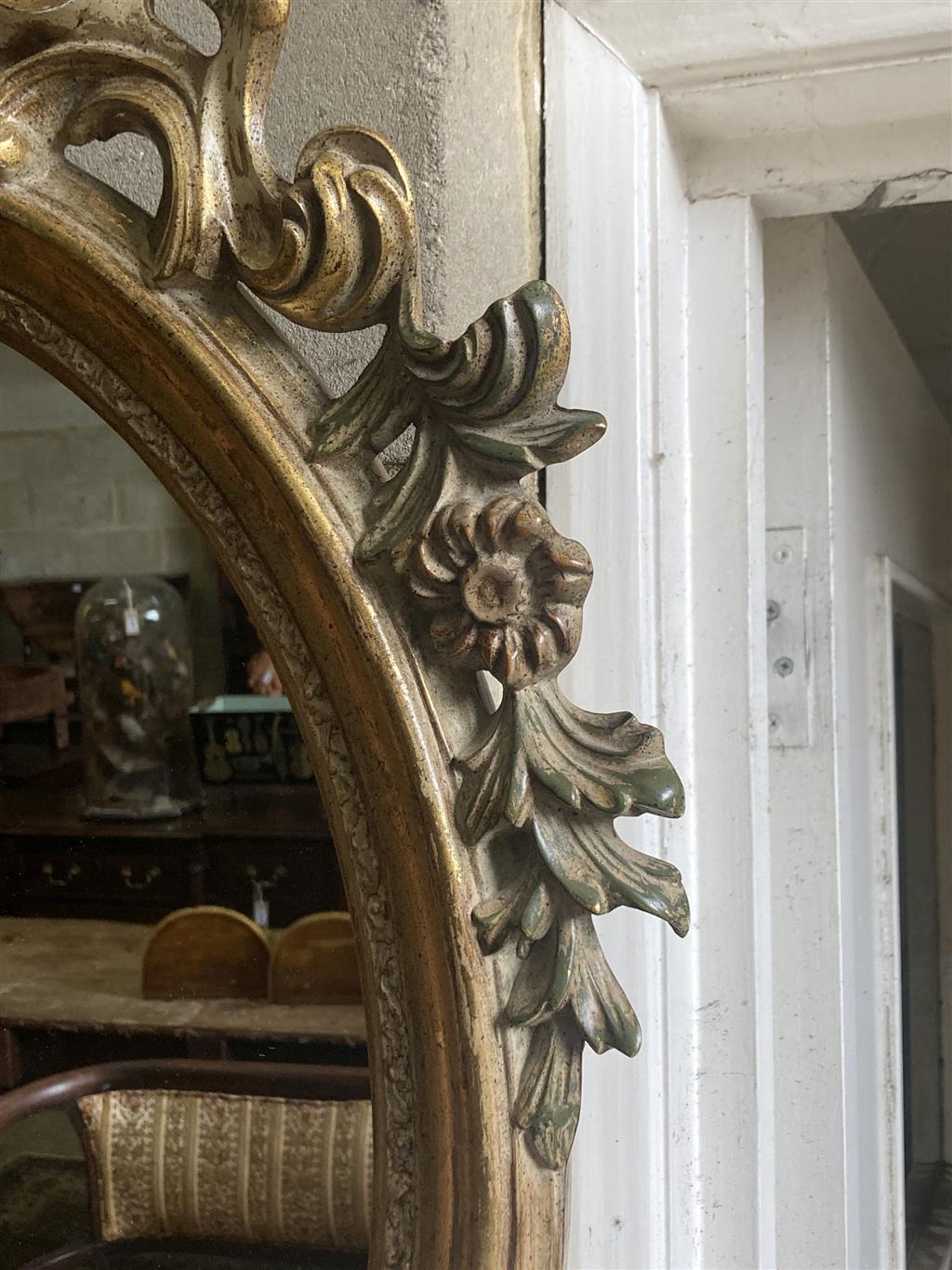 An oval giltwood wall mirror, width 59cm, height 103cm